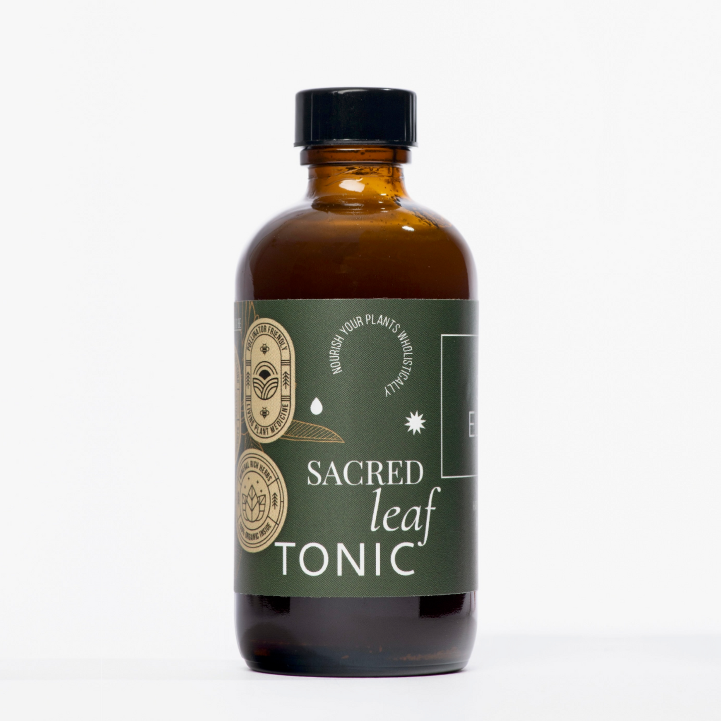 Sacred Elements Leaf Tonic in an amber glass bottle with green label, formulated to enrich soil with organic nutrients for strong plant roots